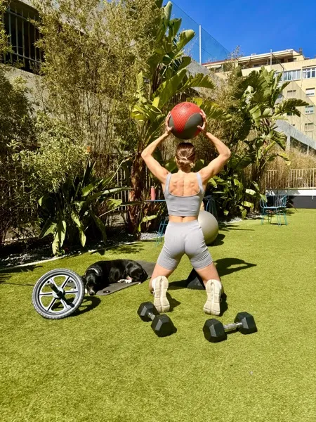 Nora training outdoors with a medicine ball